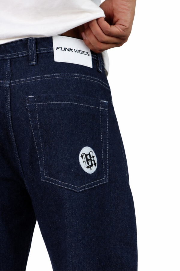 Dark blue jeans with a visible brand logo on the pocket against a white background