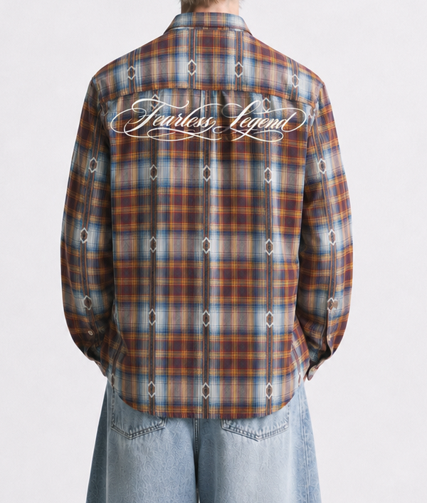 Person wearing a plaid shirt and jeans with embroidered designs on a white background