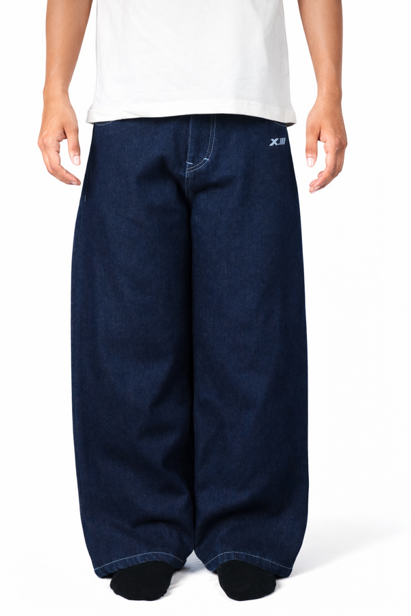 Person wearing blue baggy pants and a white shirt on a white background