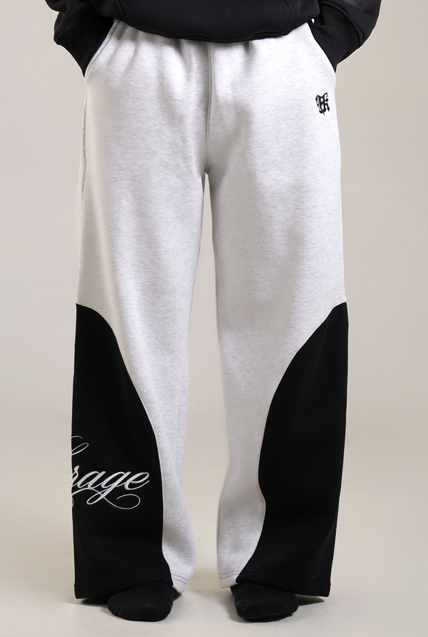 White and black sweatpants with text on a plain background