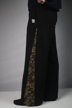 Black pants with floral pattern on a white background