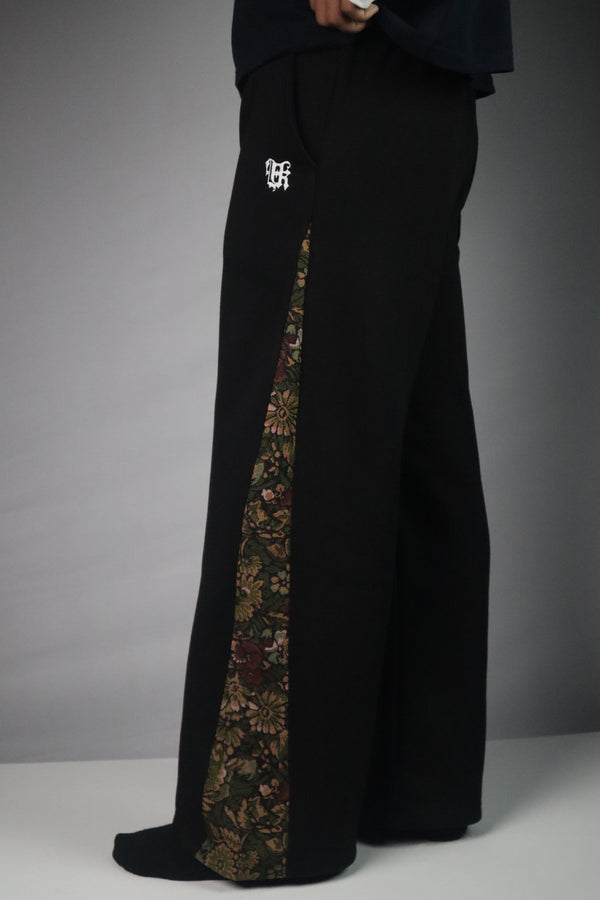 Black pants with floral pattern on a white background