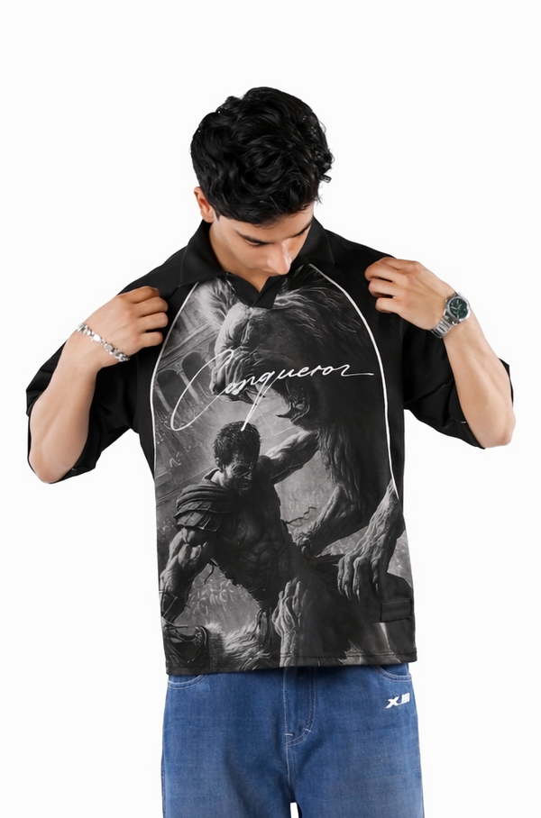 Man wearing a black graphic t-shirt and blue jeans on a white background