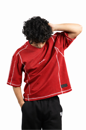 Person wearing a red shirt with white accents on a white background