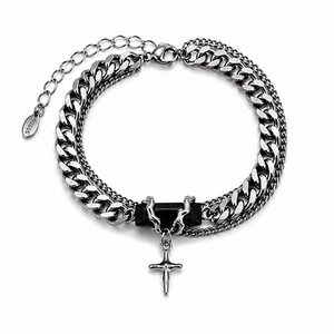 Silver chain bracelet with a cross pendant on a white background