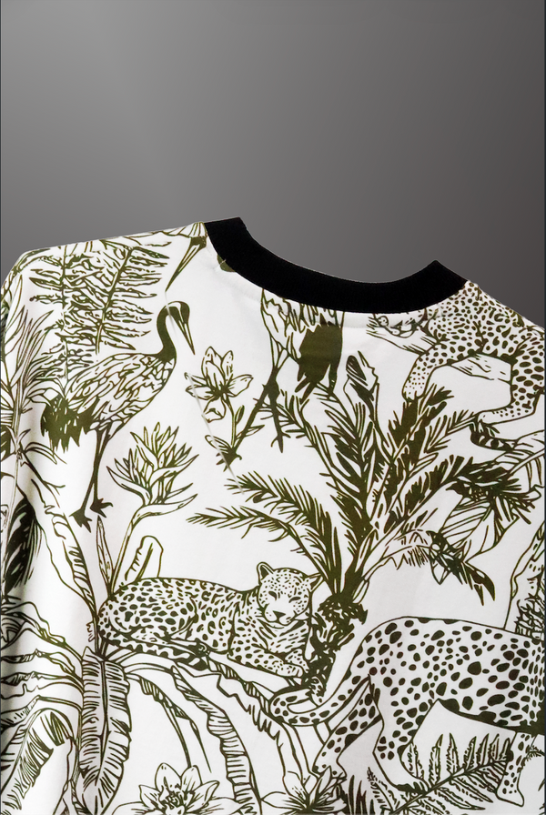 Jungle-themed shirt with leopards, birds, and plants on a gray background