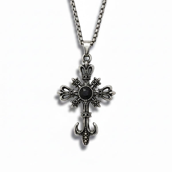 Silver cross pendant with a black gemstone on a white background