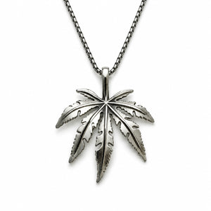 Silver cannabis leaf pendant on a chain against a white background