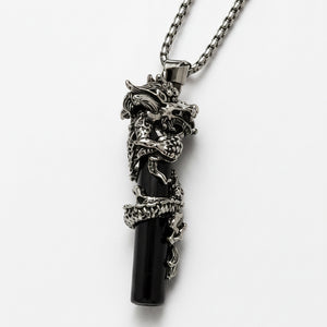 Skull-shaped pendant on a chain against a white background