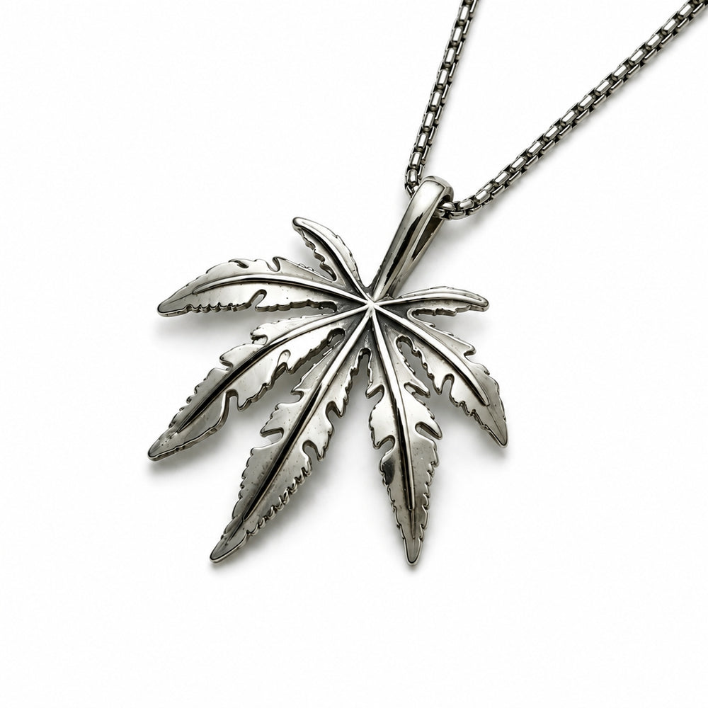 Silver cannabis leaf pendant on a chain against a white background