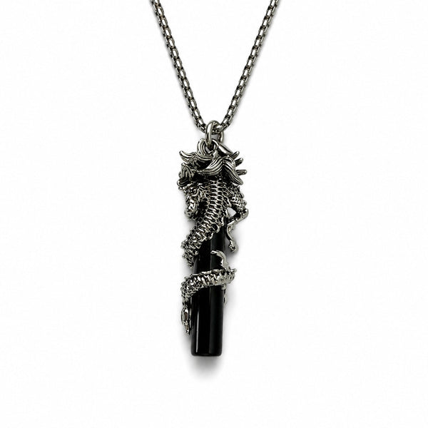 Black seahorse pendant on a chain against a white background